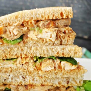 A stack of 3 coronation chicken sandwiches