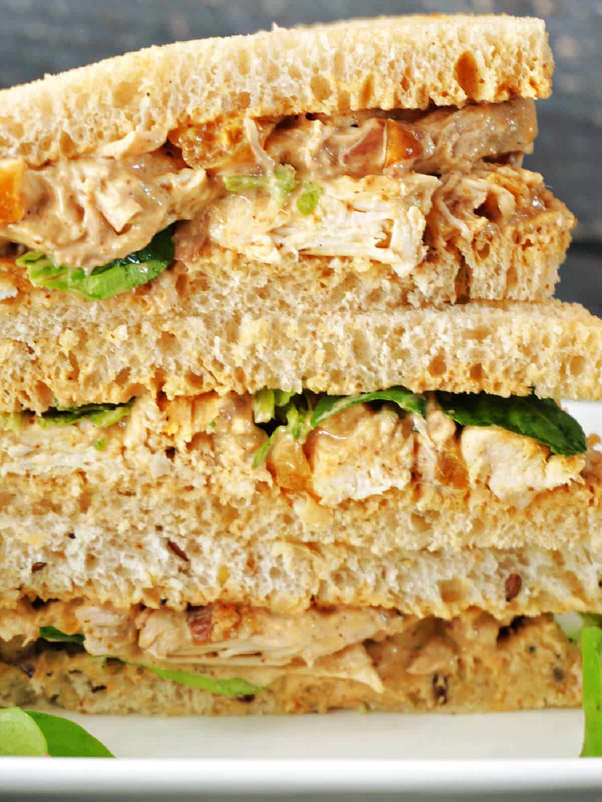 A stack of coronation chicken sandwiches.