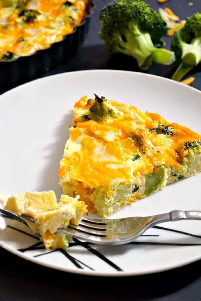 A slice of crustless quiche on a white plate