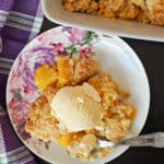 Overhead shoot of a plate with a portion of crumble and a scoop of ice cream
