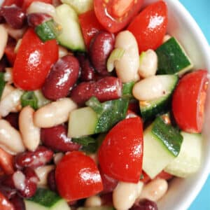 A white bowl with bean and veggie salad