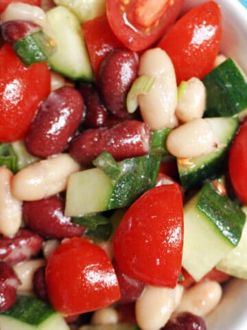 A white bowl with bean and veggie salad