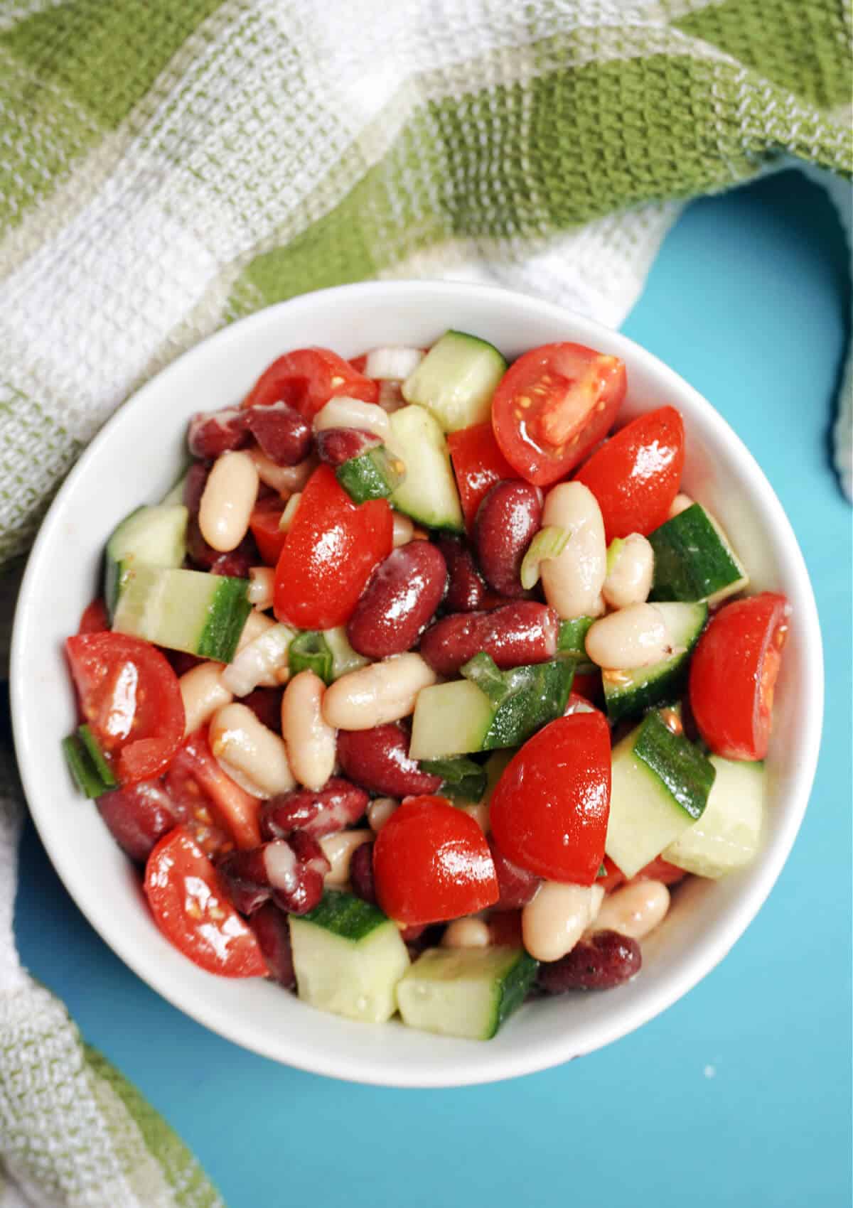 Overhead shoot of a white bowl with mixed bean salad.