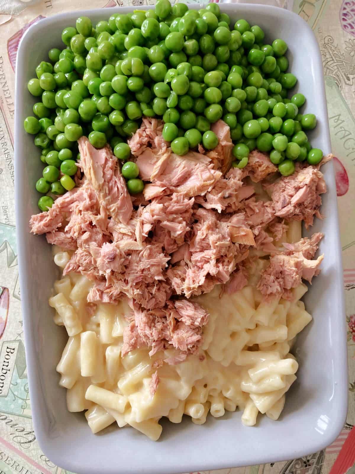 Overhead shoot of a dish with pasta, peas and tuna.