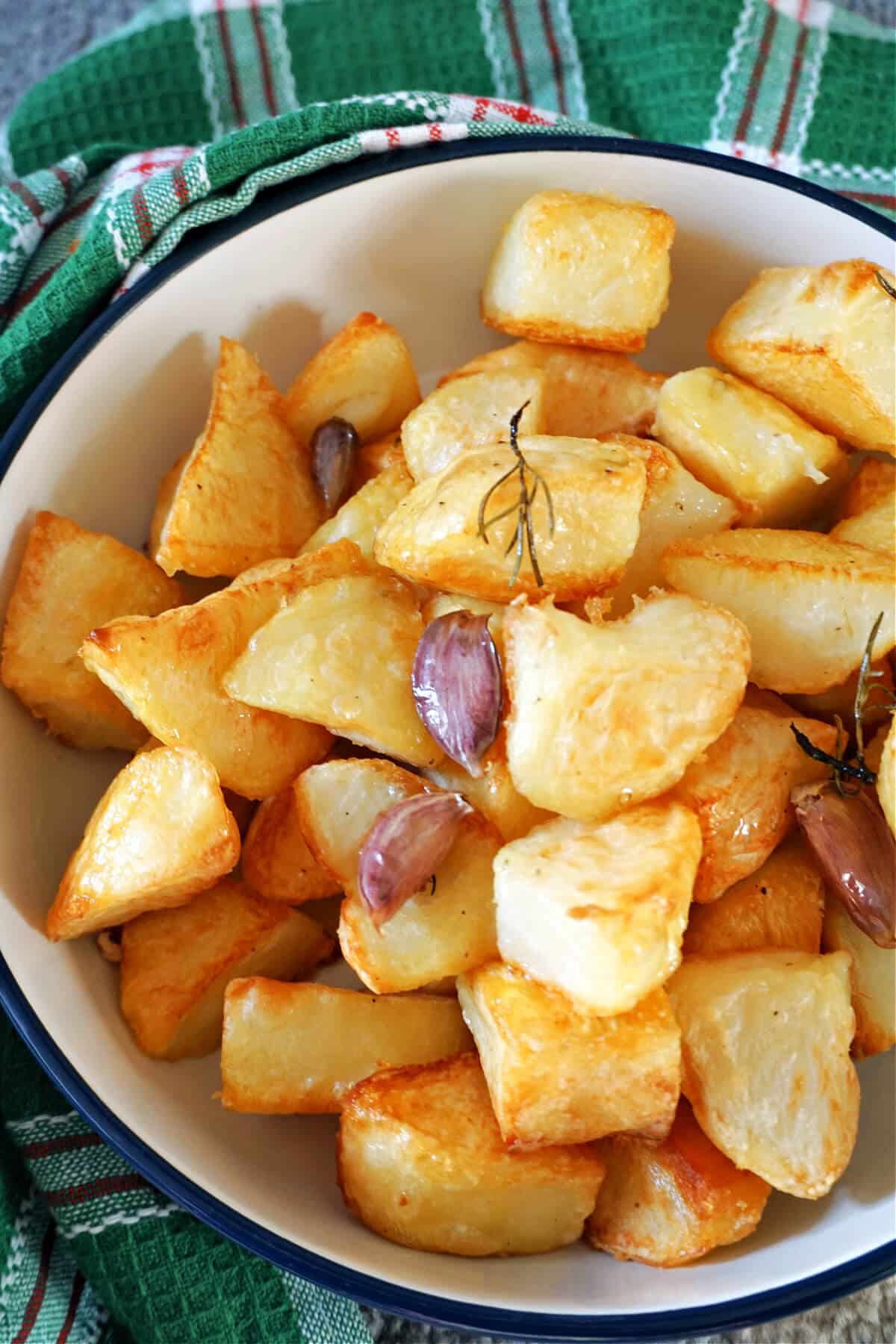 A bowl with roast potatoes.