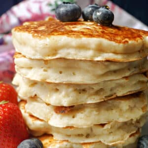 A pile of pancakes with blueberries on top