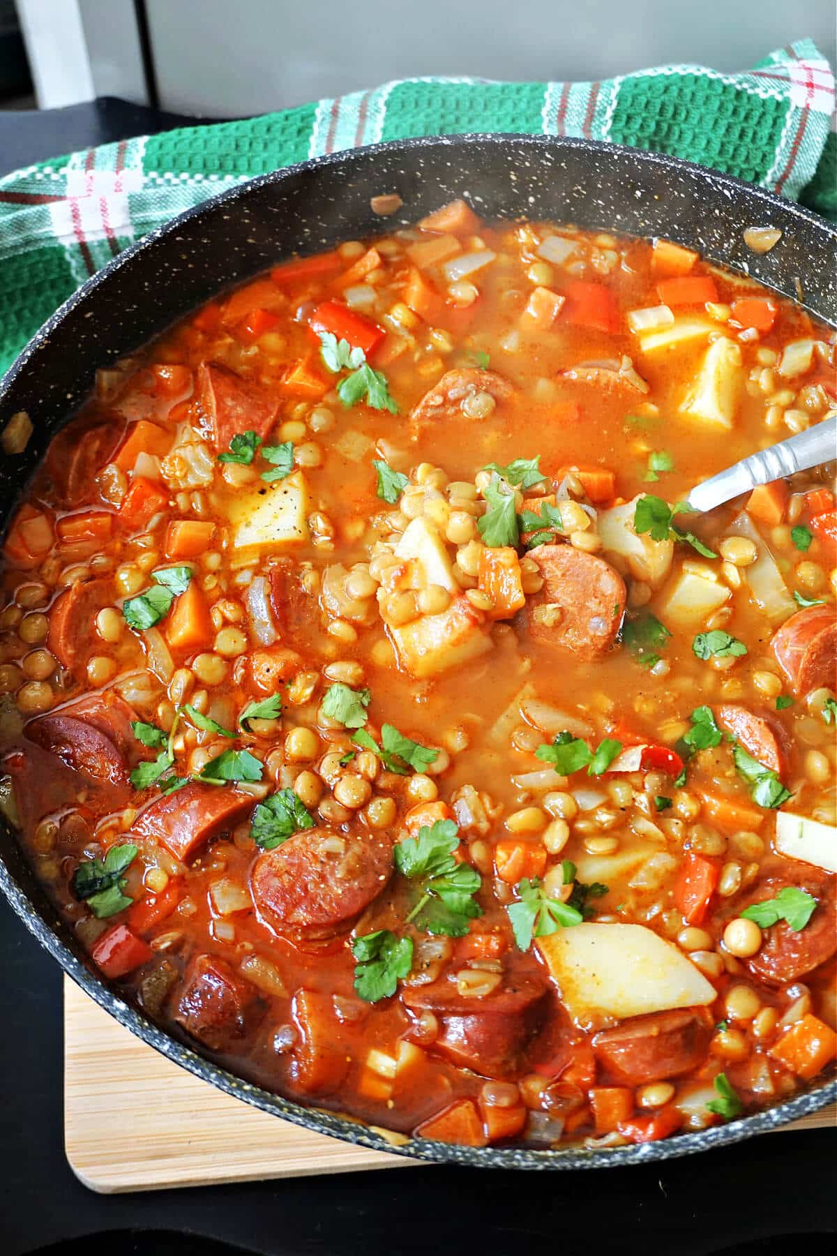 A pot with lentil and chorizo stew.