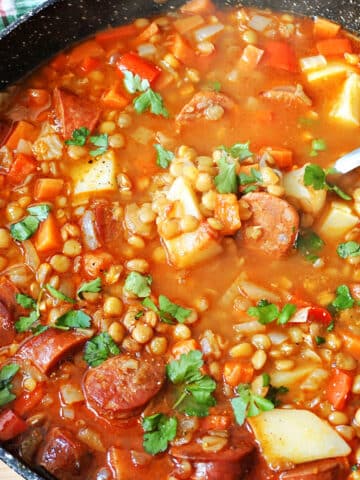 A pot with lentil and chorizo stew.