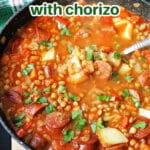 A pot with chorizo and lentil stew.
