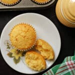 Overhead shoot of a white plate with a whole muffin and 2 halves of a muffin