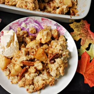 A plate of crumble with apples and pecans.