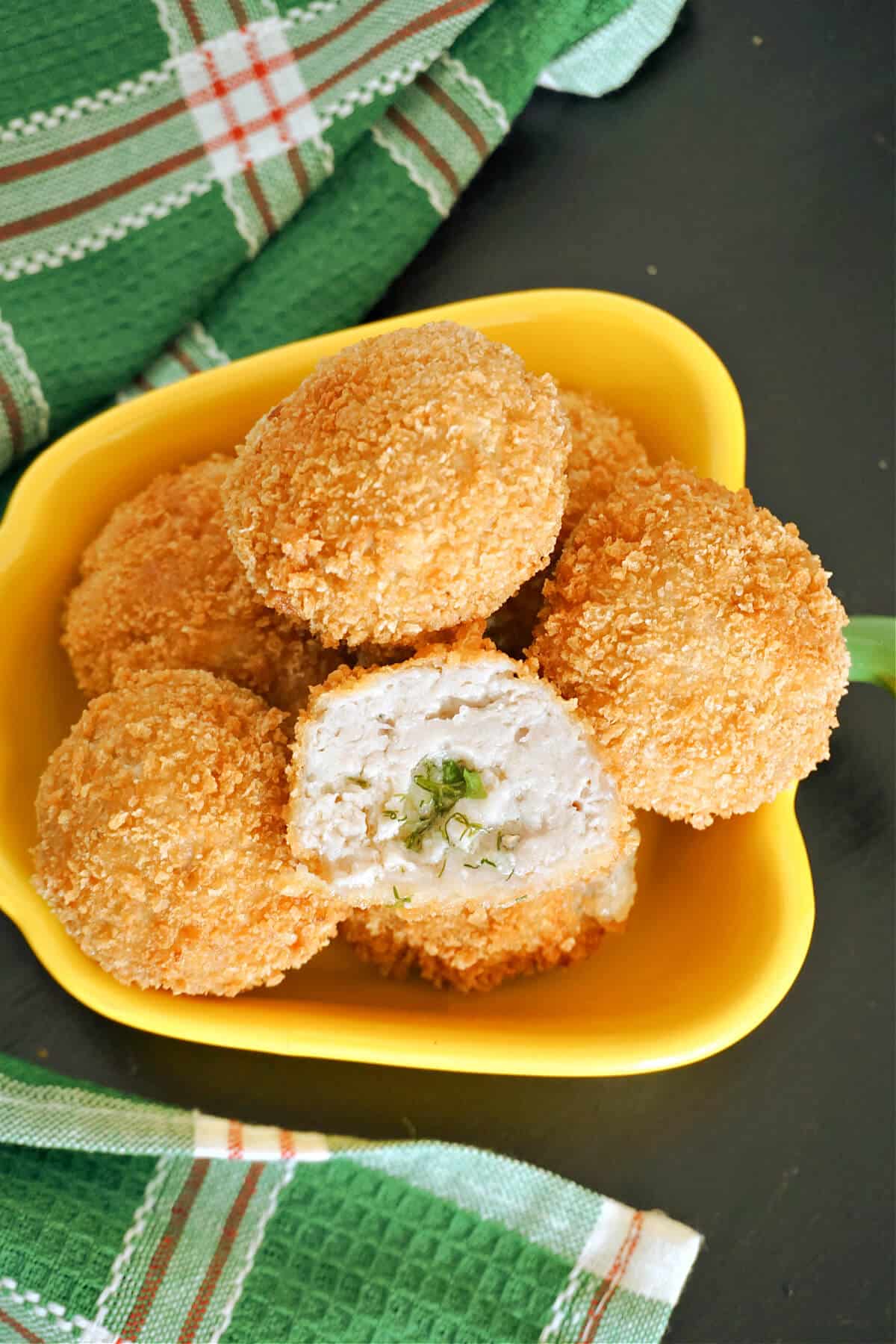 A yellow bowl with chicken balls.