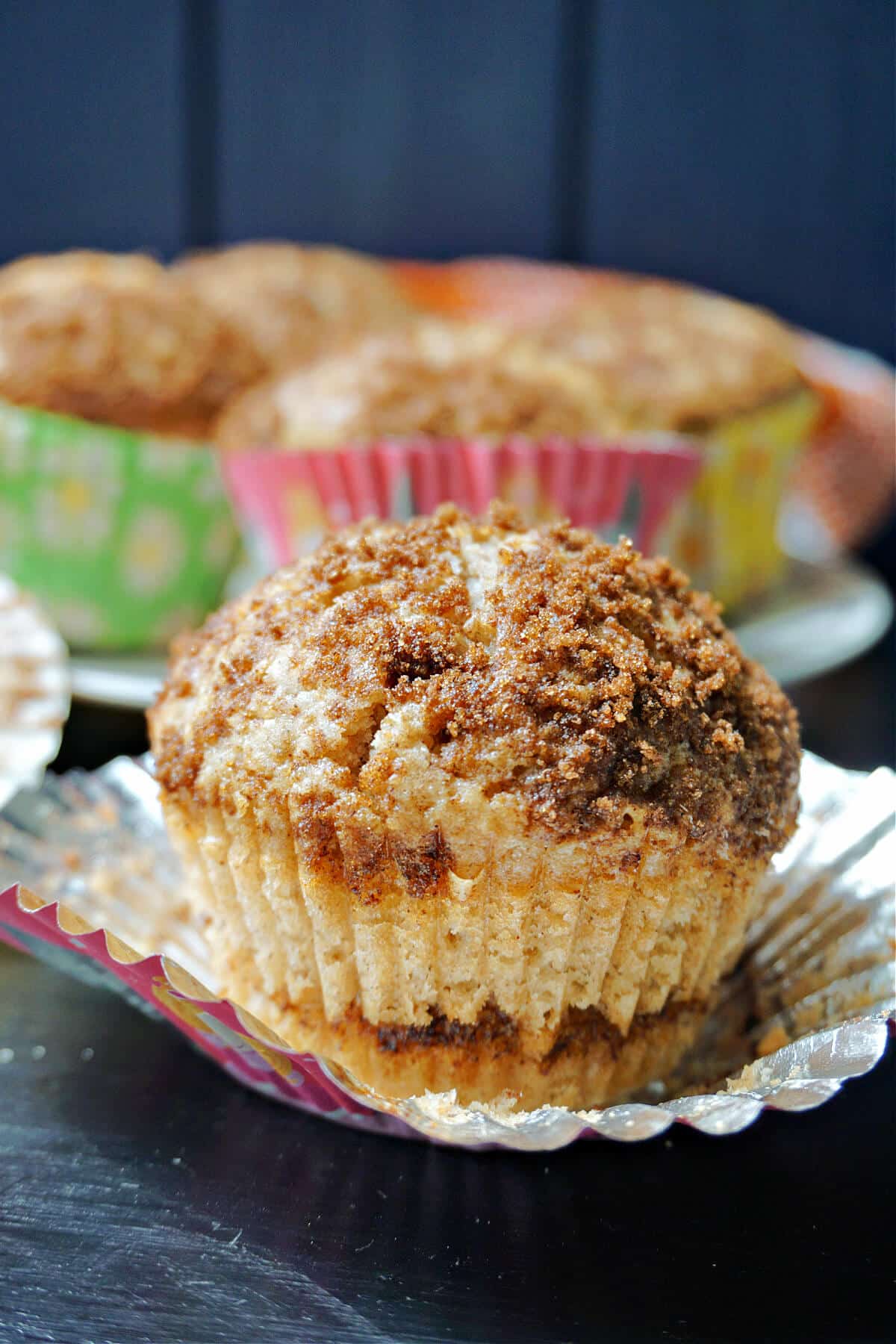 A cinnamon muffin on a muffin case.