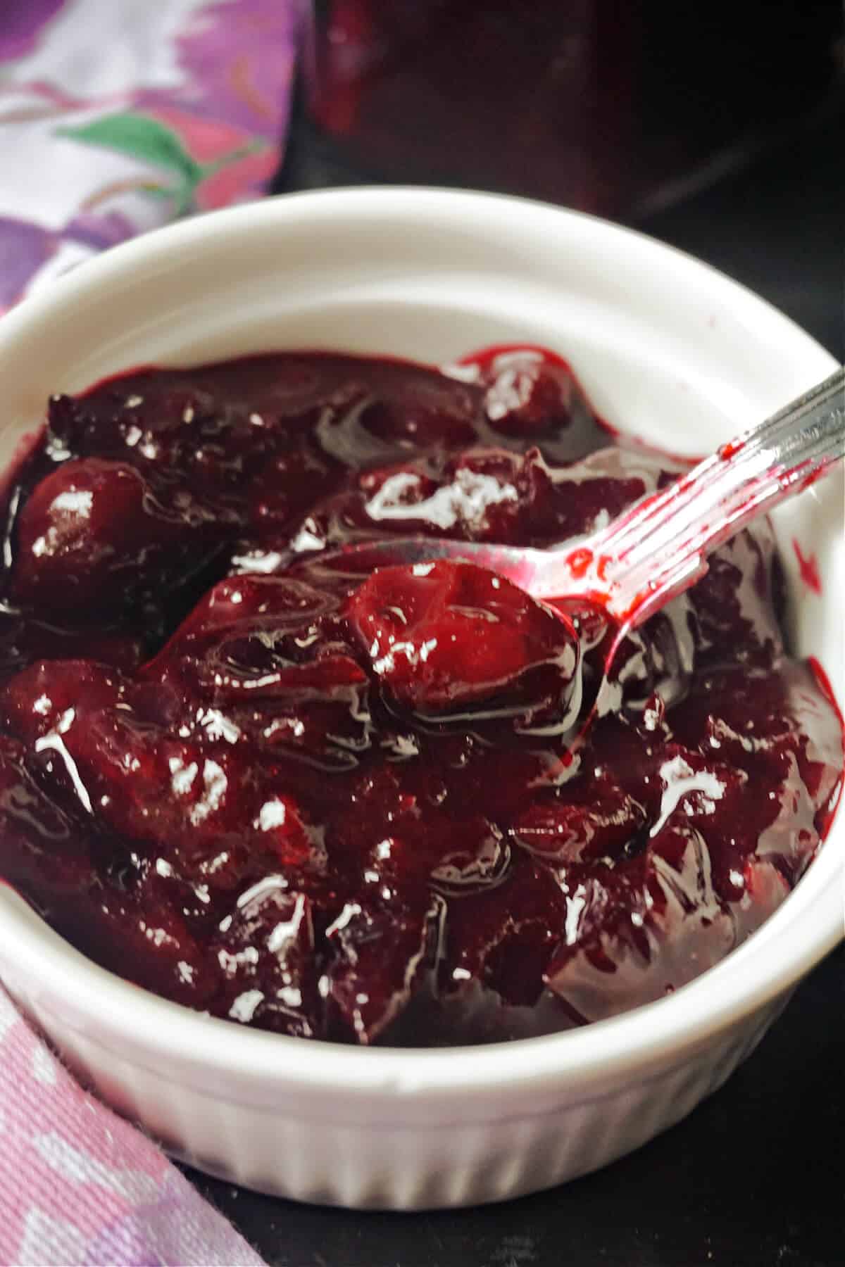 A white ramekin with jam.