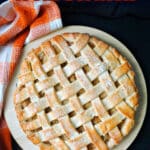 A lattice apple pie on a white plate.