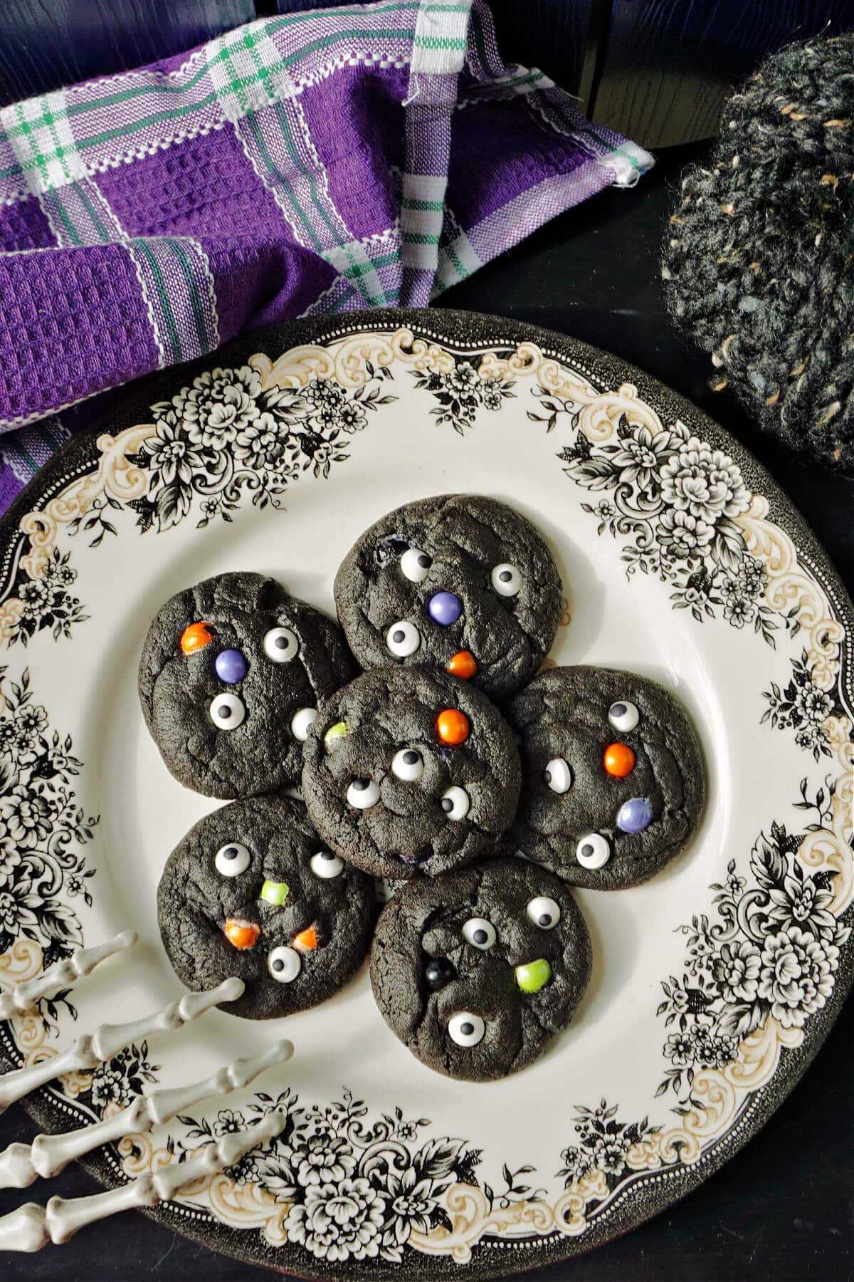 A plate with 6 black Halloween Cookies