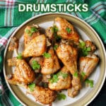 A plate with chicken drumsticks.