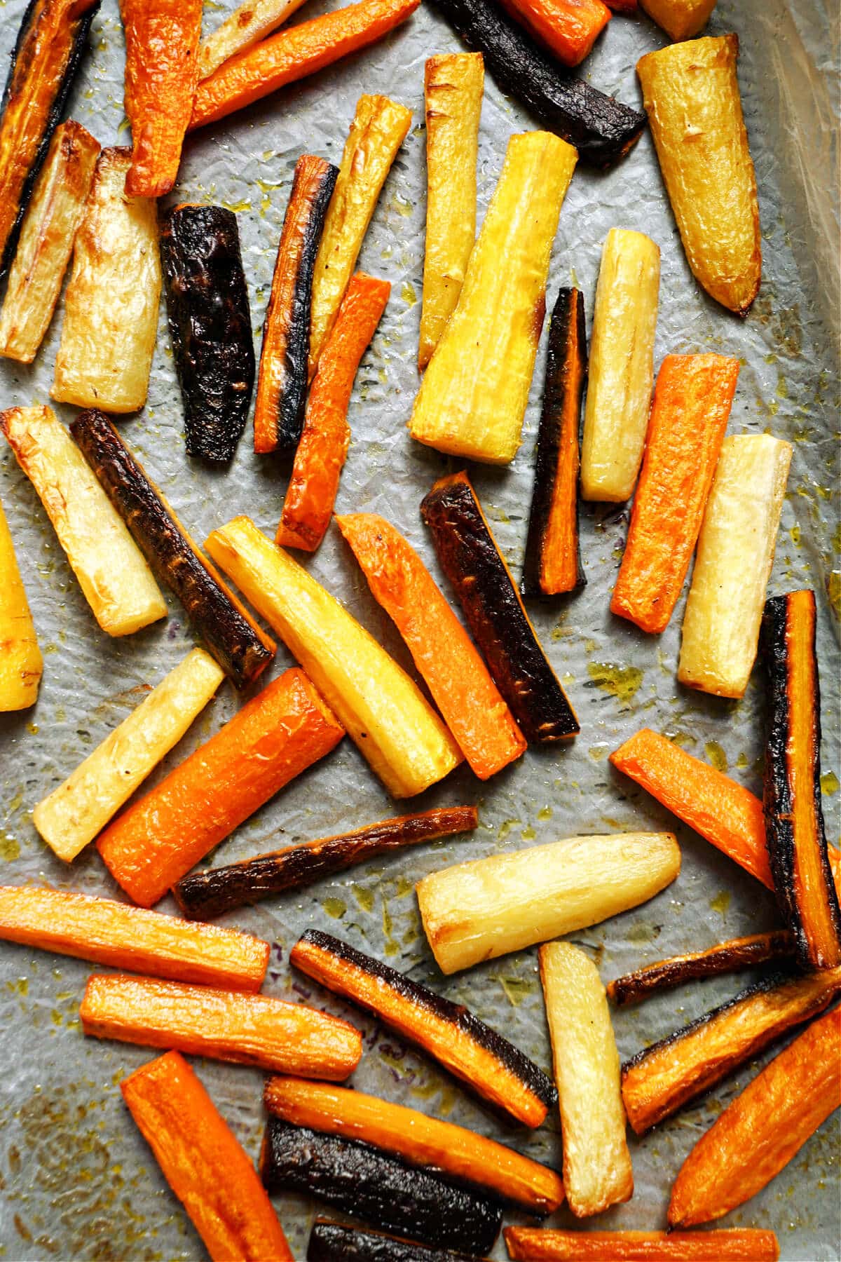 A roasting tray with roasted rainbow carrots.