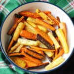 A bowl with roasted carrot sticks in different colours.
