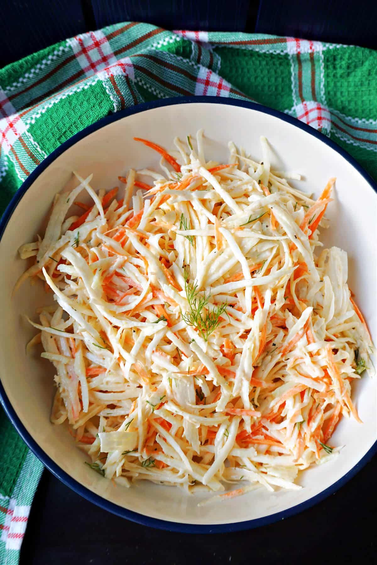 A white plate with celeriac slaw.