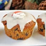 A mini Christmas cake on a white plate.