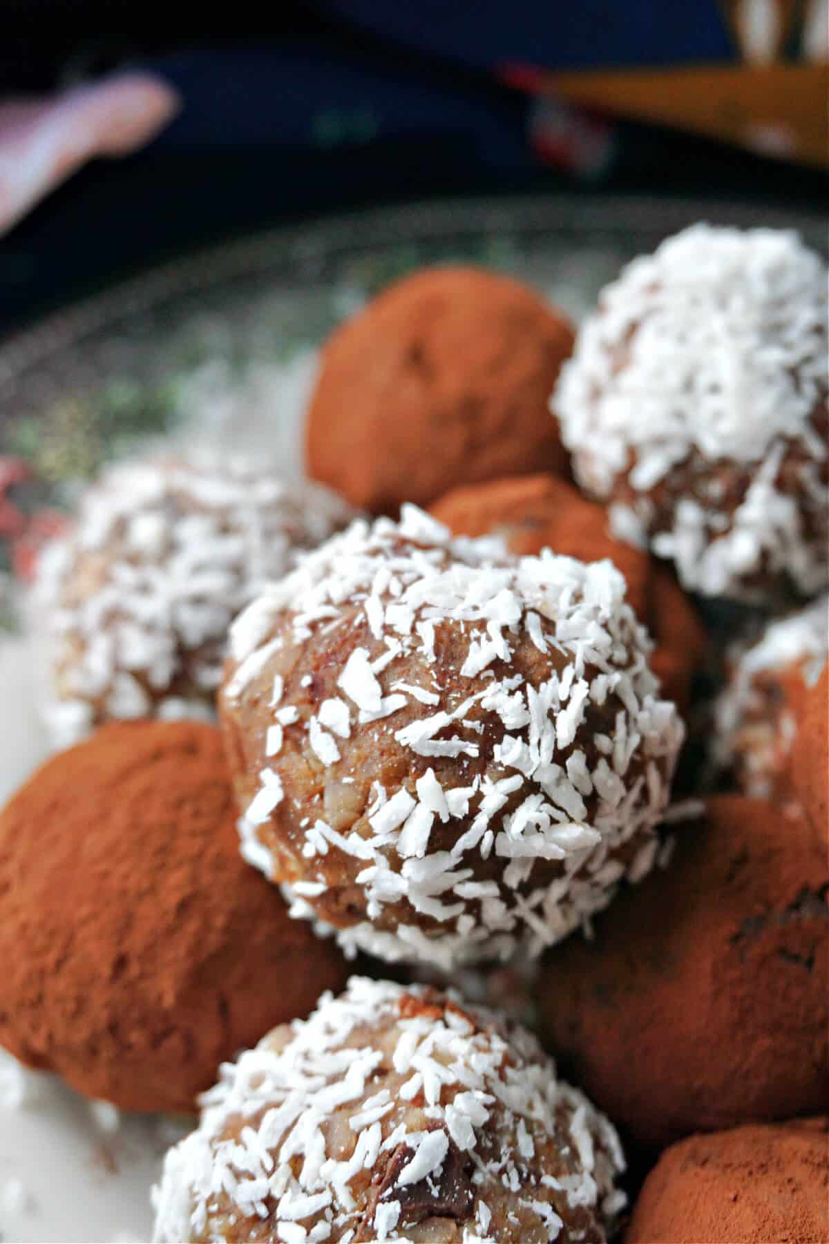 Close-up shoot of truffles dusted with cocoa powder and desiccated coconut.