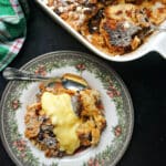 A festive plate with a portion of panettone bread pudding with custard on it.