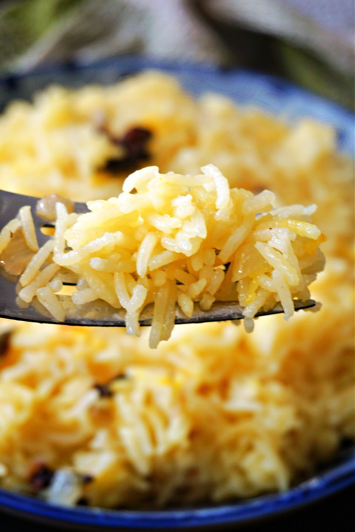 Close-up shoot of a forkful of yellow rice.