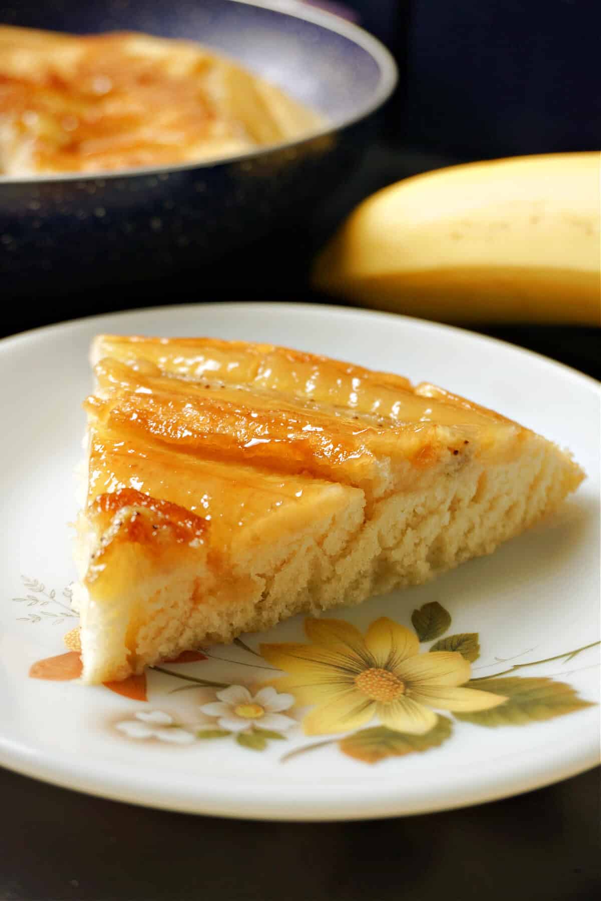 A slice of banana cake on a plate.