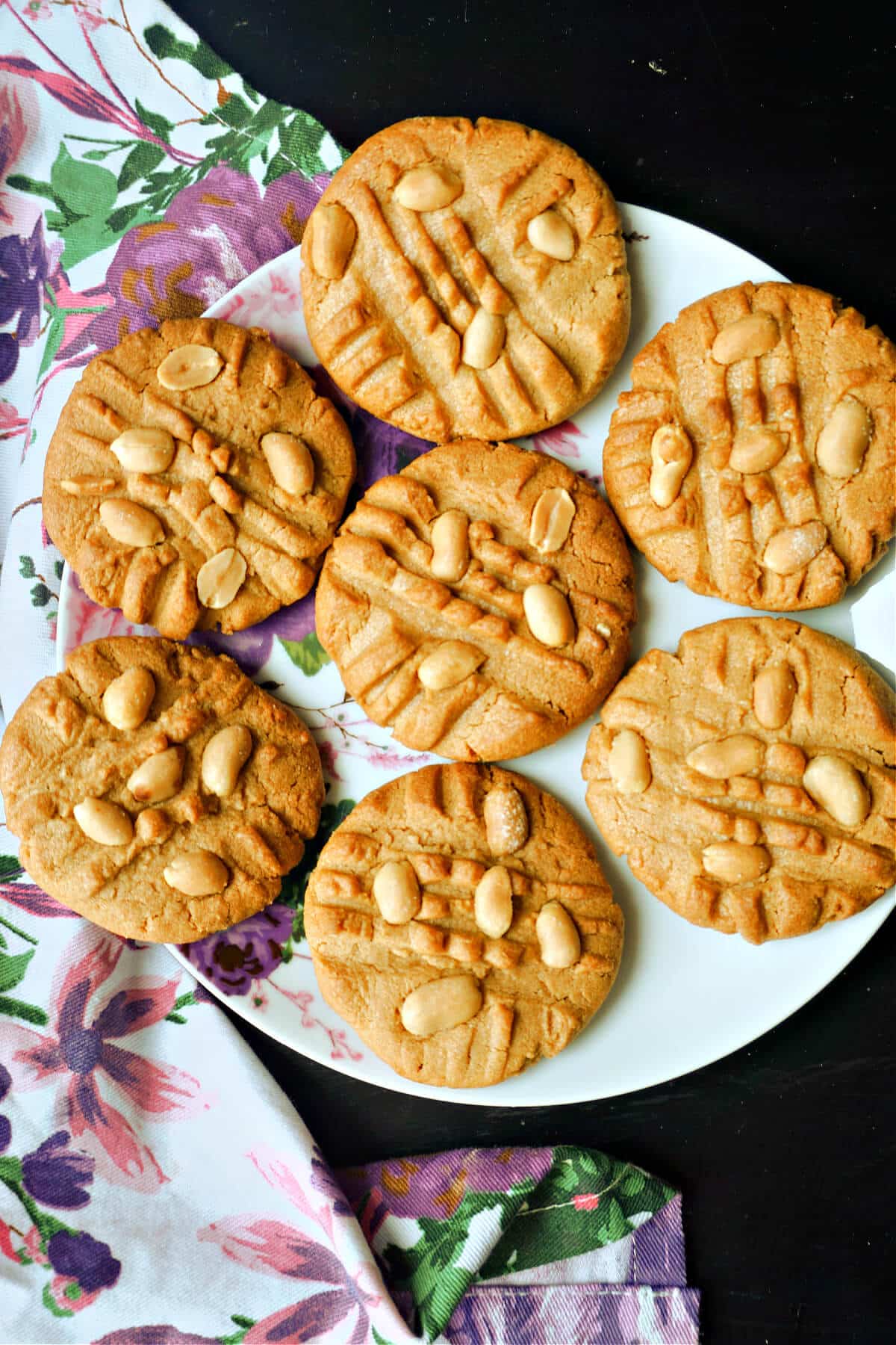 A plate with 7 peanut cookies.