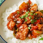 A white bowl with basmati rice and sweet and sour quorn nuggets.