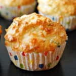 A soda bread muffin on a black table.
