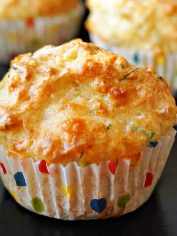 A soda bread muffin on a black table.