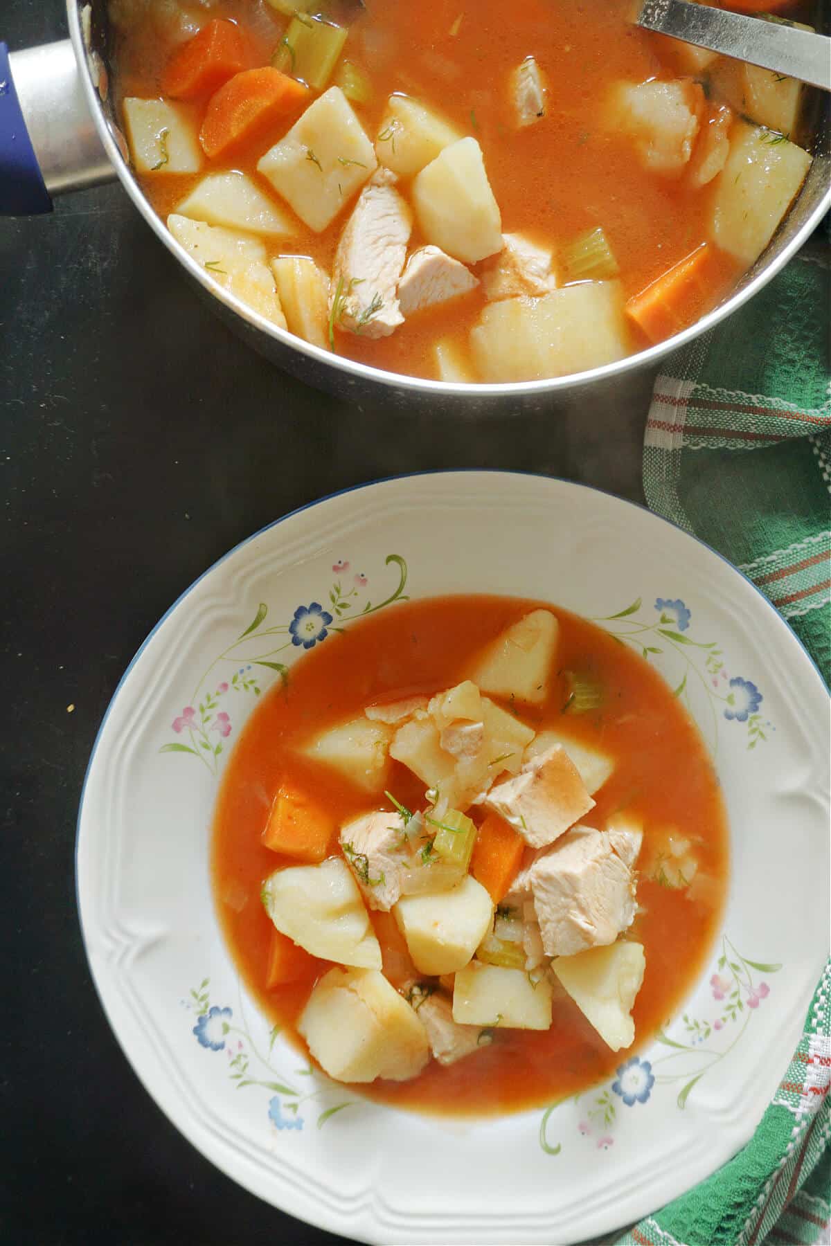 A white plate with turkey stew.