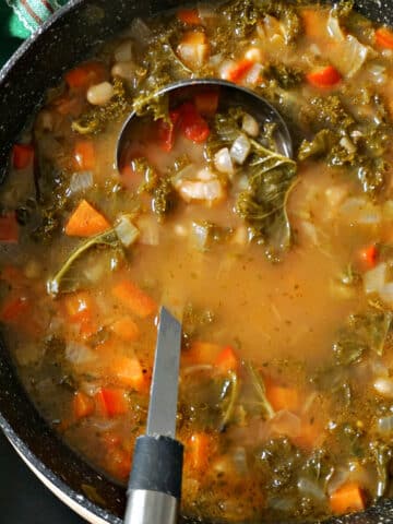 A pot with kale and bean soup.
