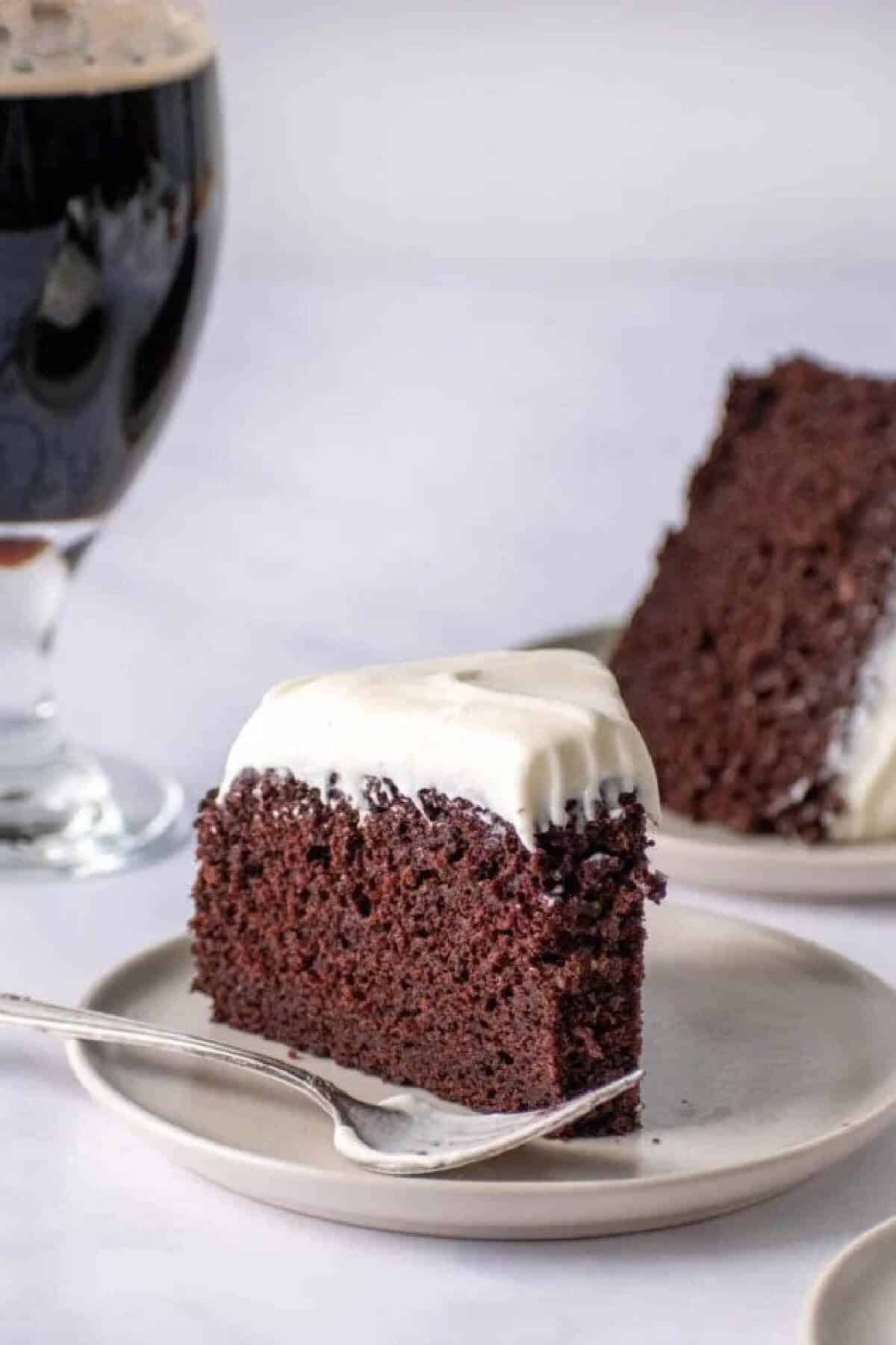 A slice of chocolate cake on a white plate.