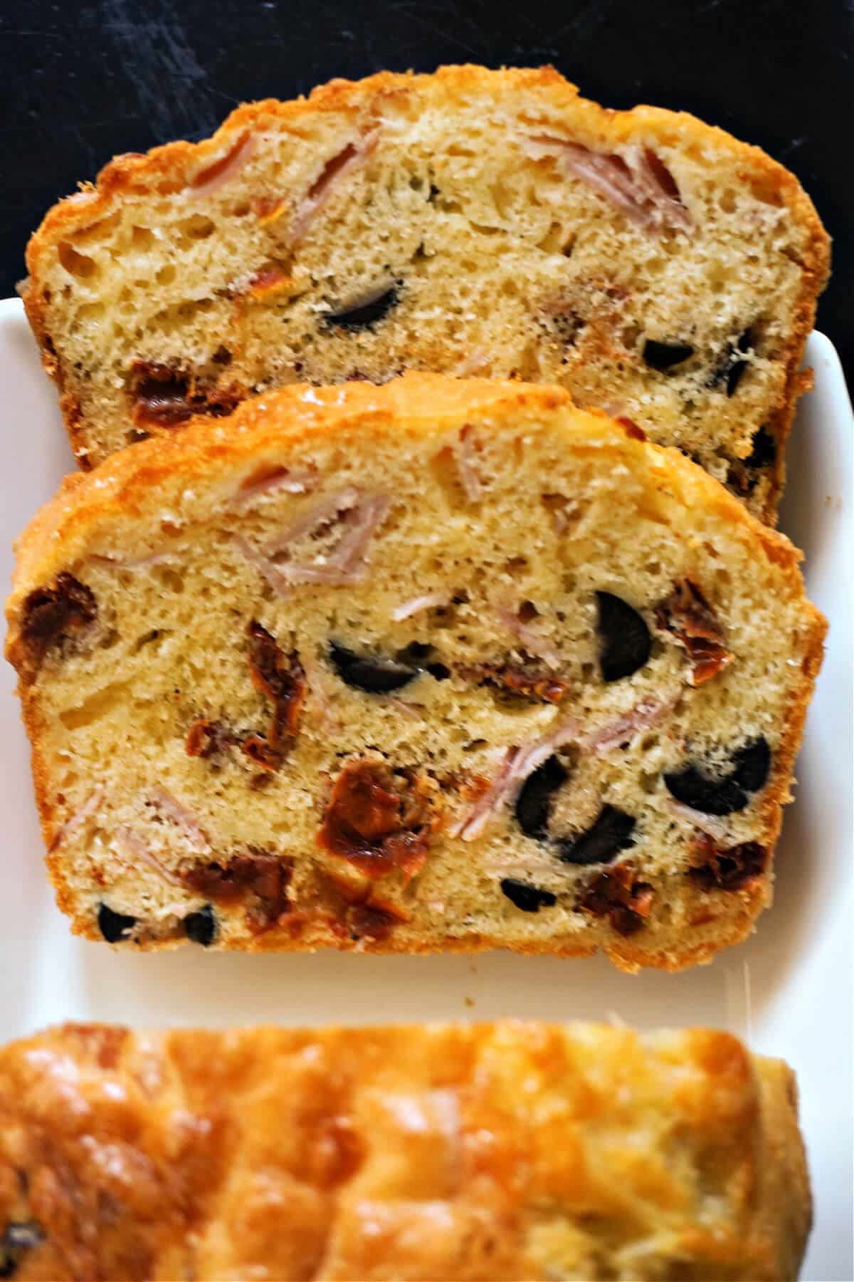 2 slices of savoury cake on a white plate.