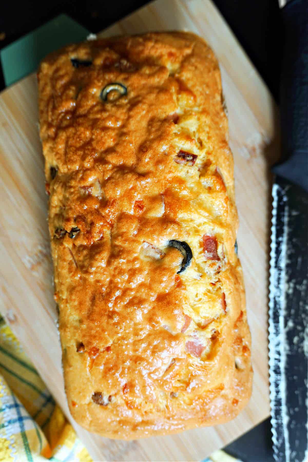 A savoury loaf cake on a wooden board.