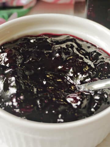 A white ramekin with blueberry jam.