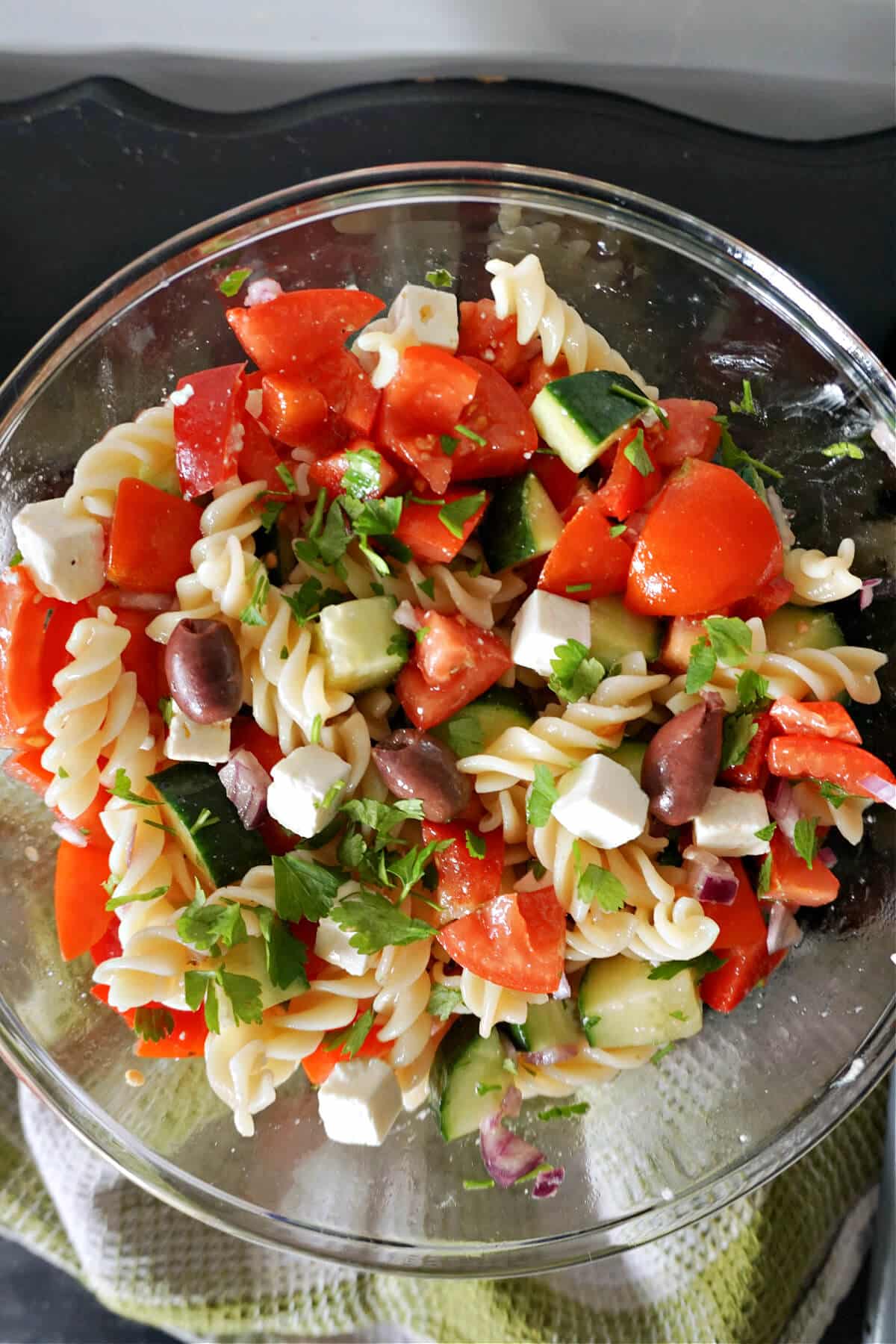 A mixing bowl with Greek pasta salad.