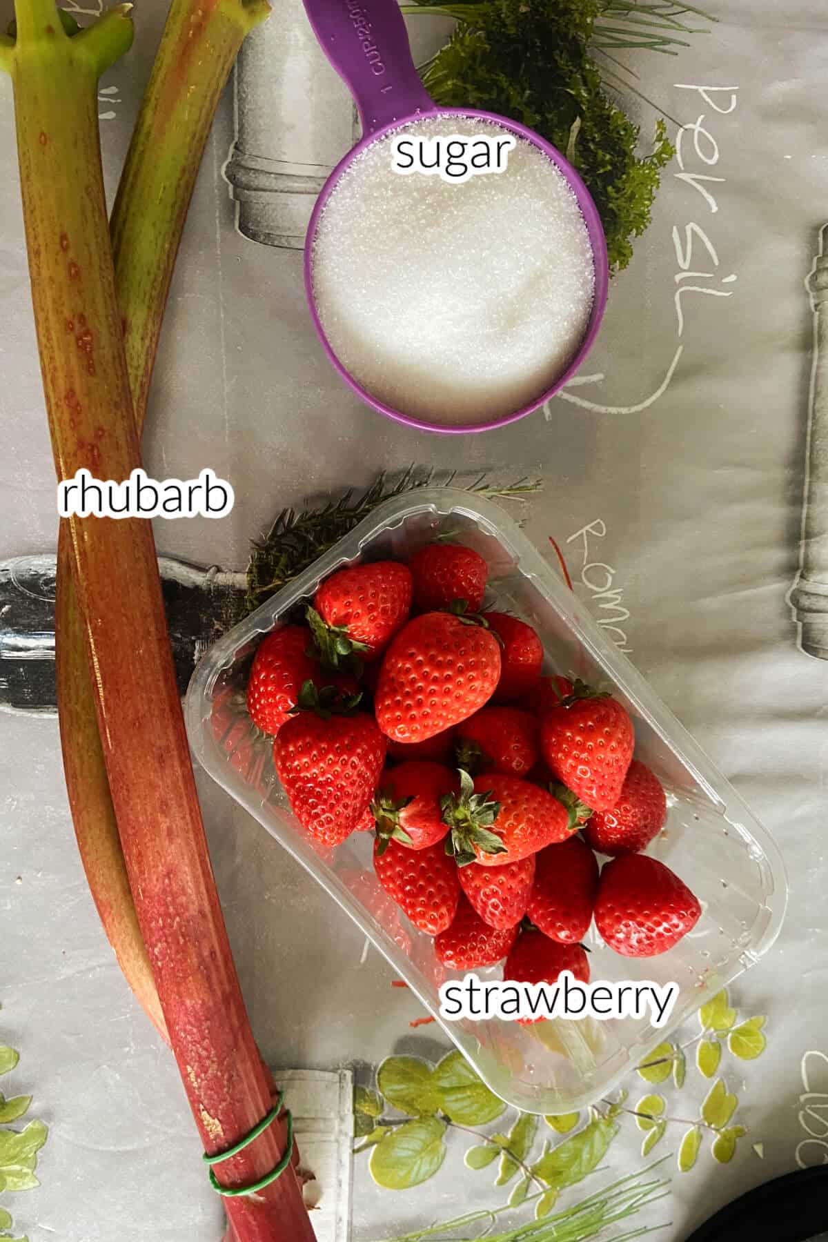 Ingredients used to make strawberry and rhubarb jam.