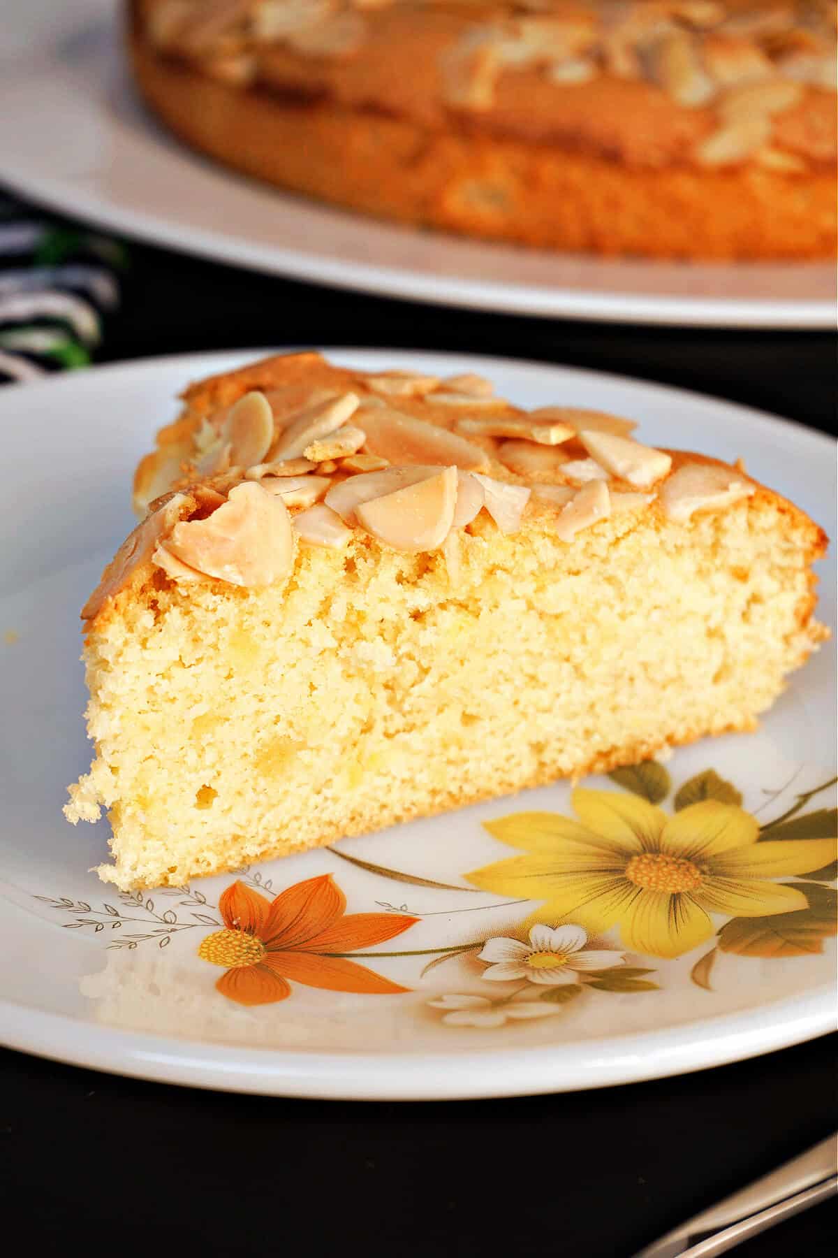 A slice of almond cake on a plate.