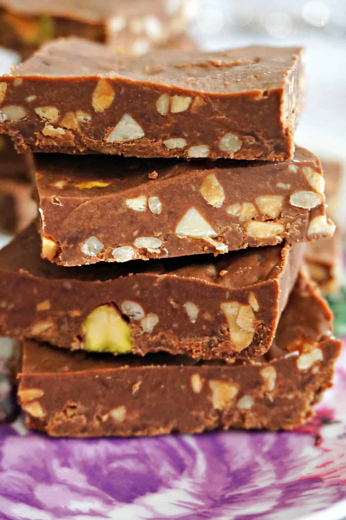 A stack of 4 crunch bars on a purple plate.