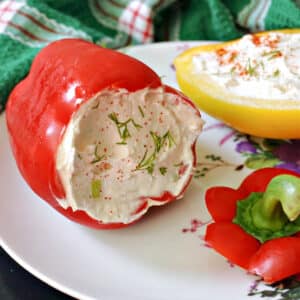 A red pepper stuffed with cheese on a white plate.