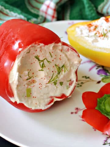 A red pepper stuffed with cheese on a white plate.