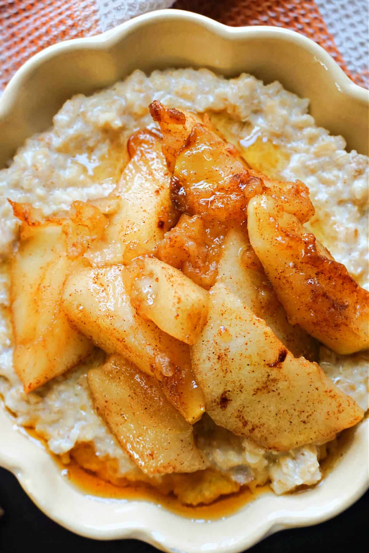 Close-up shoot of a bowl of porridge topped with apple compote.