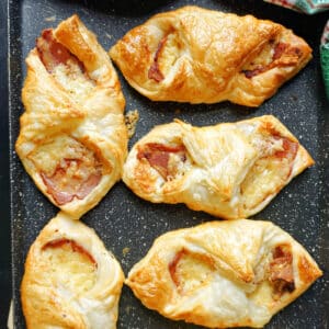 A baking tray with 6 bacon cheese bites.