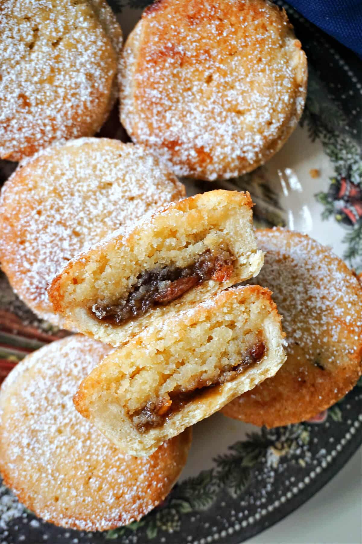 2 halves of a mince pie on top of other whole pies.