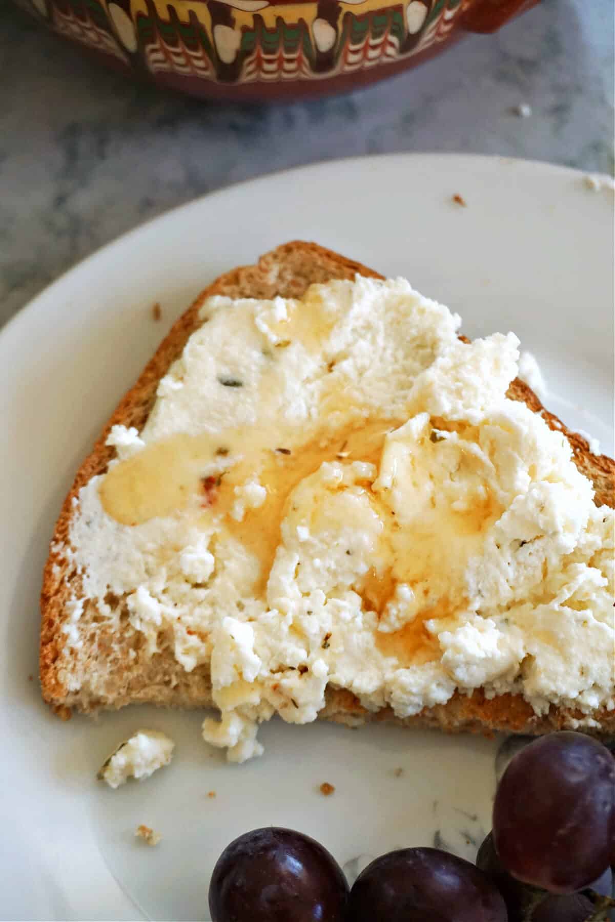 Half a slice of toast with ricotta and honey.