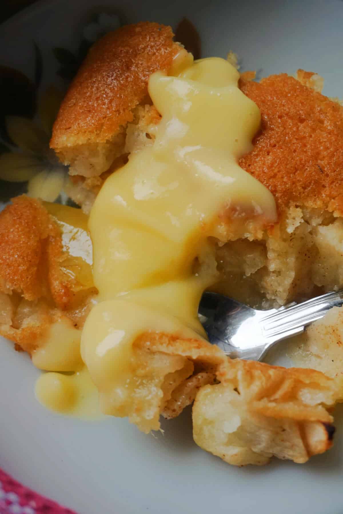 Close-up shoot of a portion of apple pudding on a plate.